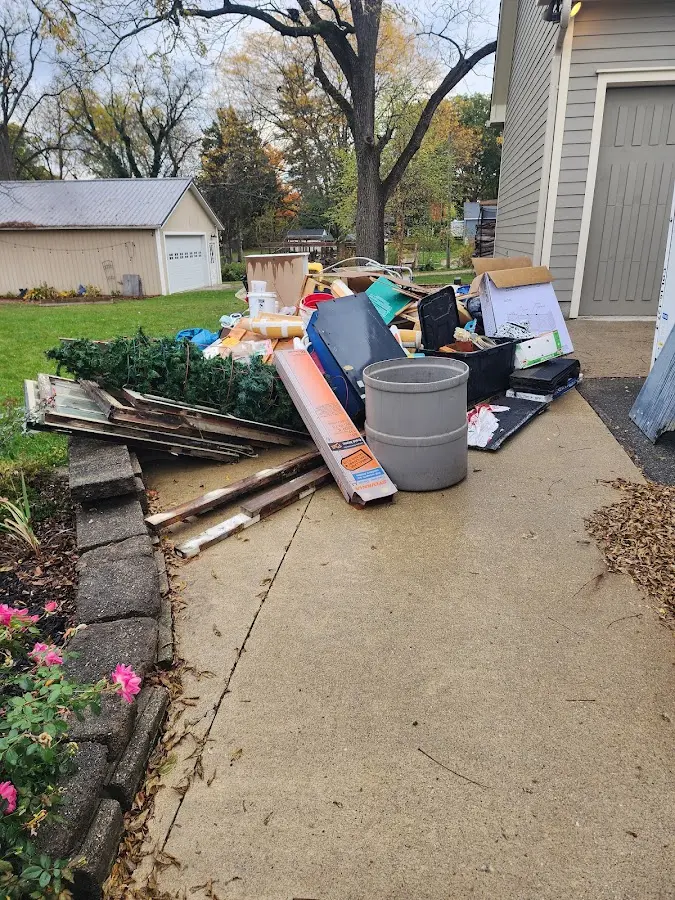 Dumpster being loaded with debris for Residential Dumpster Rental in Weston